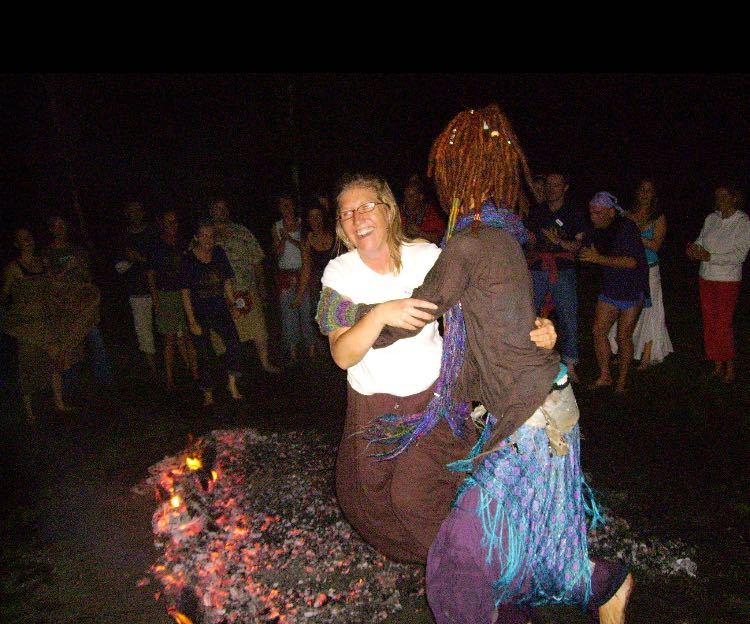 Image of Mariko dancing across hot coals during a fire walk