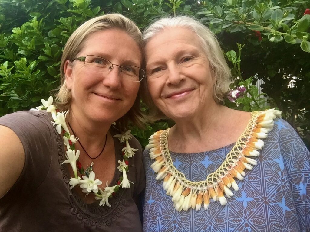 Image of adult Mariko and her mother Heide both wearing flower lei